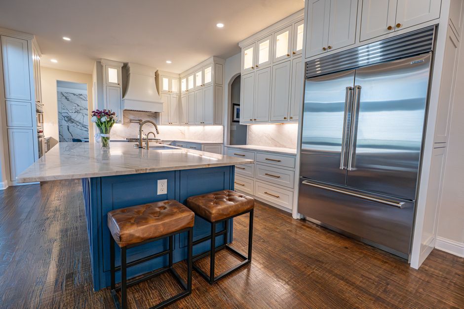 Kitchen with marble countertops, a center island and stainless steel appliances