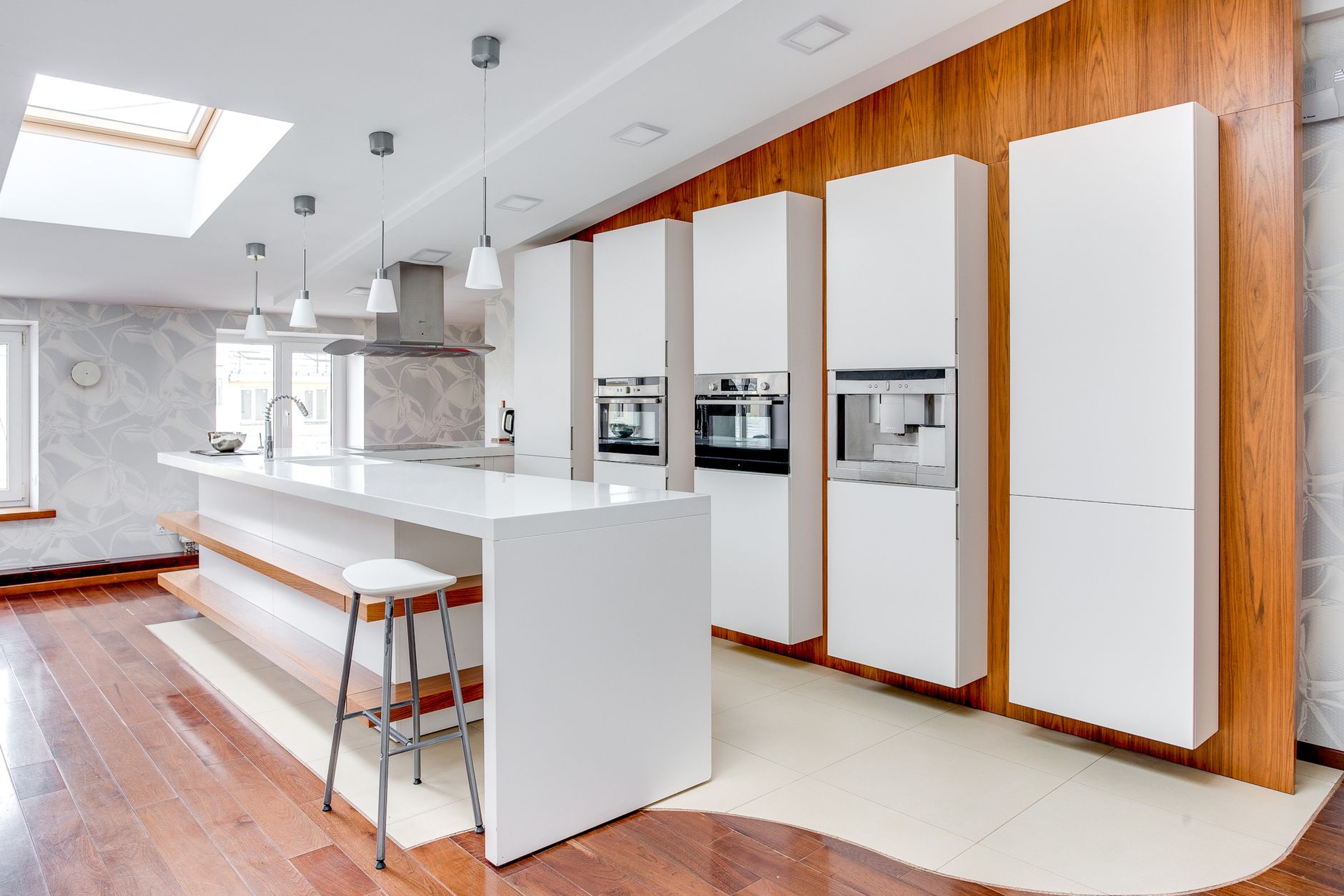 Sleek modern kitchen featuring white cabinets, wooden accents, and a spacious design highlighting minimalist in Irvine, CA